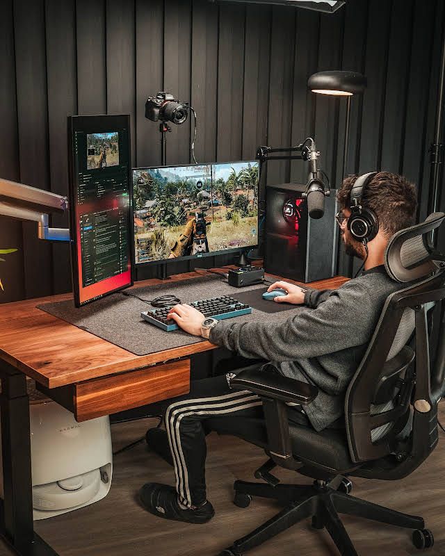 Gaming setup with standing desk and multiple screens